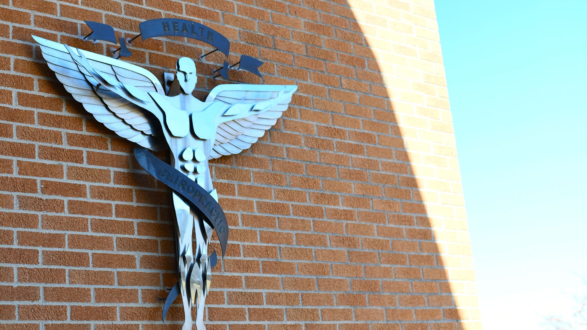 Montgomery Health Center chiropractic emblem on a brick wall