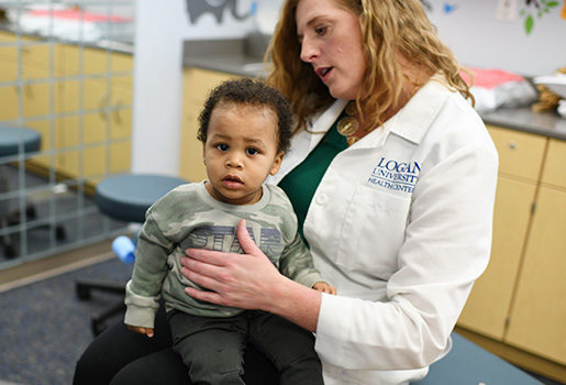 Chiropractor working with child patient.