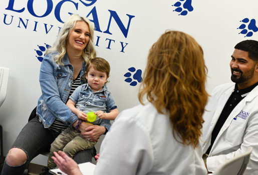 Chiropractor speaking with patient.